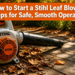 Stihl leaf blower and instruction manual on a wooden workbench.